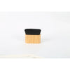 A black makeup brush with a wooden handle for applying tan and foundation.