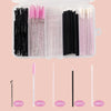 An open clear storage case filled with various makeup brushes in black, pink, and white shades.