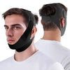 A man wearing a black adjustable jawline shaper strap designed to lift the chin.