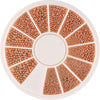A circular tray of gold mixed stainless steel bead nail art decorations arranged in radial sections.