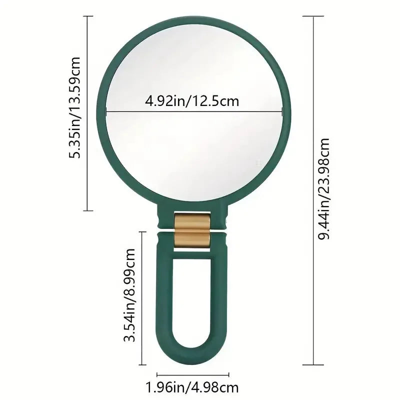A magnifying fold-up handheld vanity mirror with a green frame and a round glass lens.