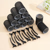 A set of black self-grip hair rollers for creating heatless curls and volume, displayed on a light background.