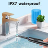 A hand is using an electric rotary toothbrush to clean a sink, demonstrating IPX7 waterproof capability.
