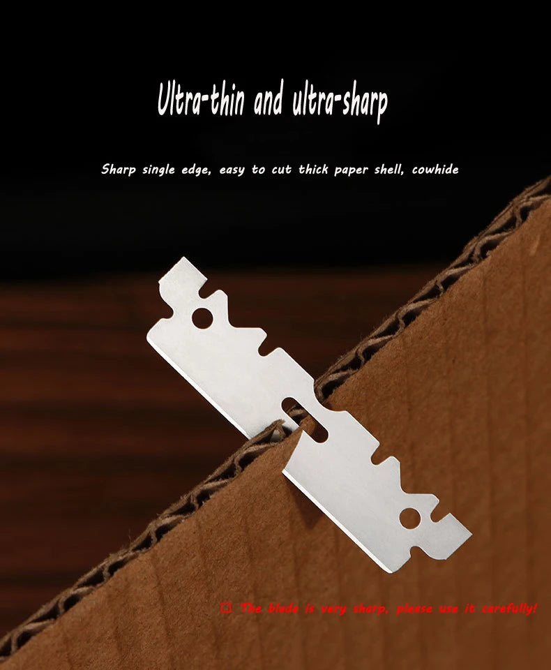 A close-up of a stainless steel single-edged razor blade placed on brown cardboard.