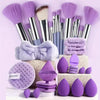 A collection of purple makeup brushes, sponges, and applicators displayed on a white surface.
