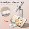 A portable UV nail lamp is shown as a cell phone holder, clamping onto a smartphone to provide light for manicures.