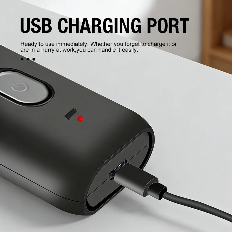 A close-up of a black electric portable shaver with a USB charging port connected to a cable.