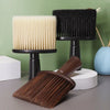 A set of black and beige soft bristle hair duster brushes displayed on a table.
