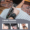 A hand is using a black T-Blade trimmer for beard and carving on a man's face.