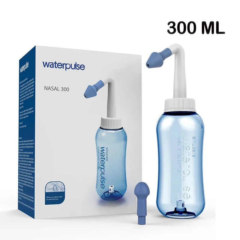 A clear plastic nasal irrigation rinse bottle with a white and blue nozzle is shown next to its packaging.