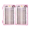 A pair of pink false eyelash extensions with black cluster lashes displayed on a clear plastic tray.