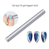 A silver magnet stick with three iridescent blue cat eye nails attached for 3D nail art
