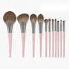 A set of ten professional makeup brushes with varying sizes and shades displayed horizontally.