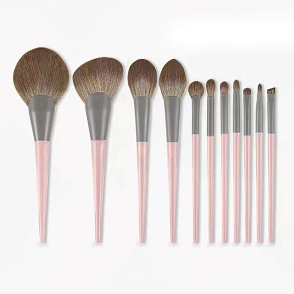 A set of ten professional makeup brushes with varying sizes and shades displayed horizontally.