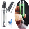 A clear glass perfume bottle and a green refill spray are shown next to a blue component.