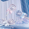 A collection of iridescent pearl hand mirrors with pink and blue accents are displayed on a blue surface.