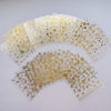A collection of gold star nail art stickers and 3D decals for acrylic nails displayed in a fan shape.