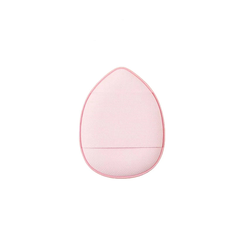 A pink mini finger puff foundation applicator tool with a textured surface.