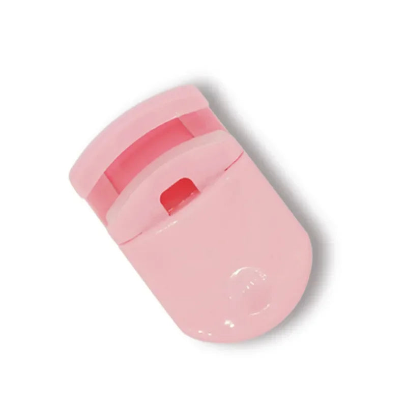 A pink mini folding eyelash curler set with a clear protective cap.