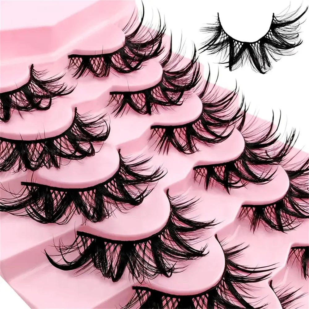A close-up of pink false eyelashes showing a dramatic, voluminous, and curled wet look style.