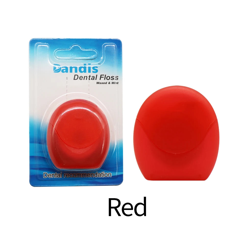 Red reusable dental floss threader with a blue and white packaging background