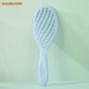 A white hollow-out detangling hair brush with scalp massage bristles is displayed against a light green background.
