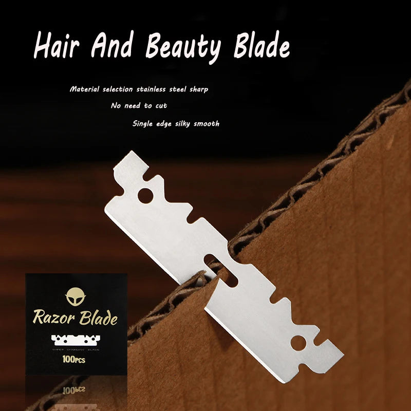 A silver stainless steel single-edged razor blade is shown partially cut out of brown cardboard packaging.