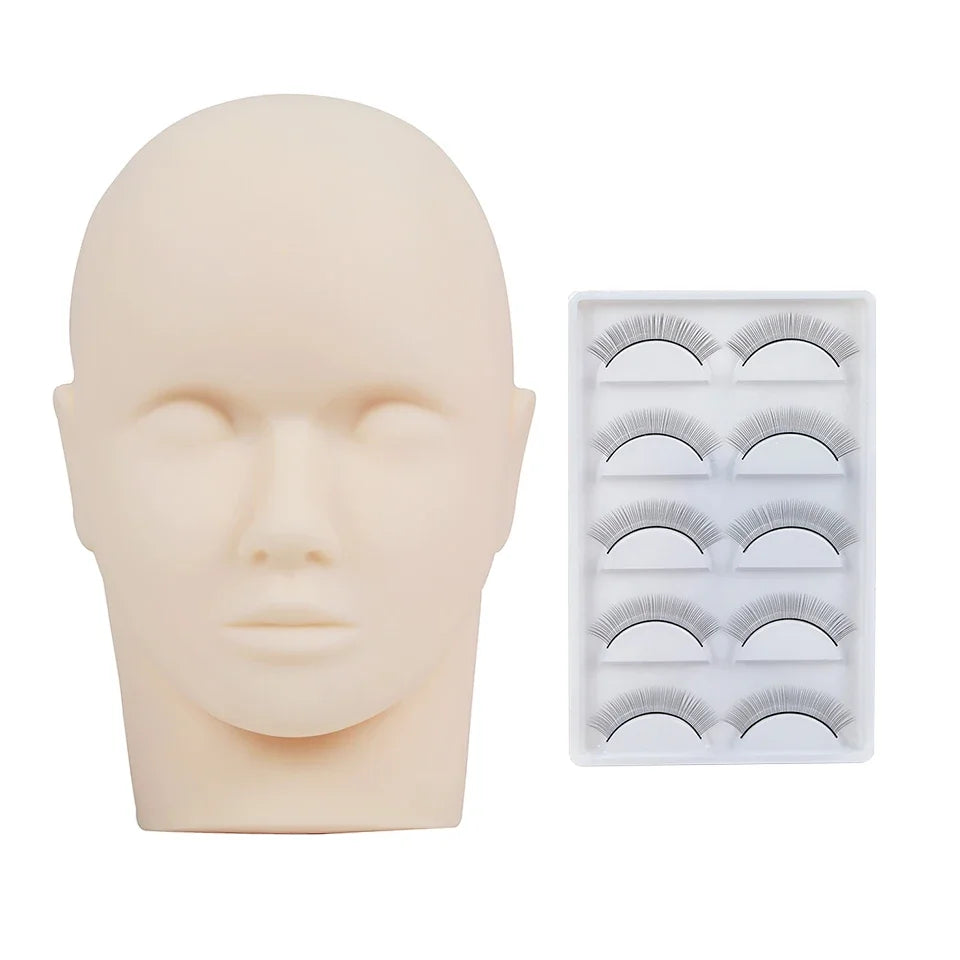 A realistic silicone mannequin head used for practicing eyelash extensions, shown next to a tray of false lashes.
