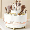 A white makeup organizer with a rotating base holds various makeup brushes and tools.