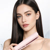 A woman holds a pink cold mist hair straightener against her long dark hair.