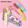 A collection of 30 random double-sided nail files and buffing blocks in various colorful patterns on a pink background.
