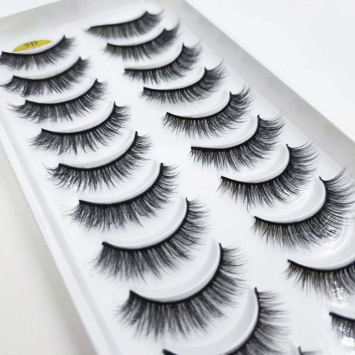A tray of natural 3D mink false eyelashes displayed on a white background.
