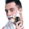 A man is using a precision rotary electric shaver on his face, with white shaving foam visible.