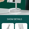 A white foldable LED makeup mirror is shown on a table, highlighting features like an adjustable angle and USB charging port.