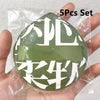 A set of five white makeup puffs packaged in a clear plastic bag with a green storage box.