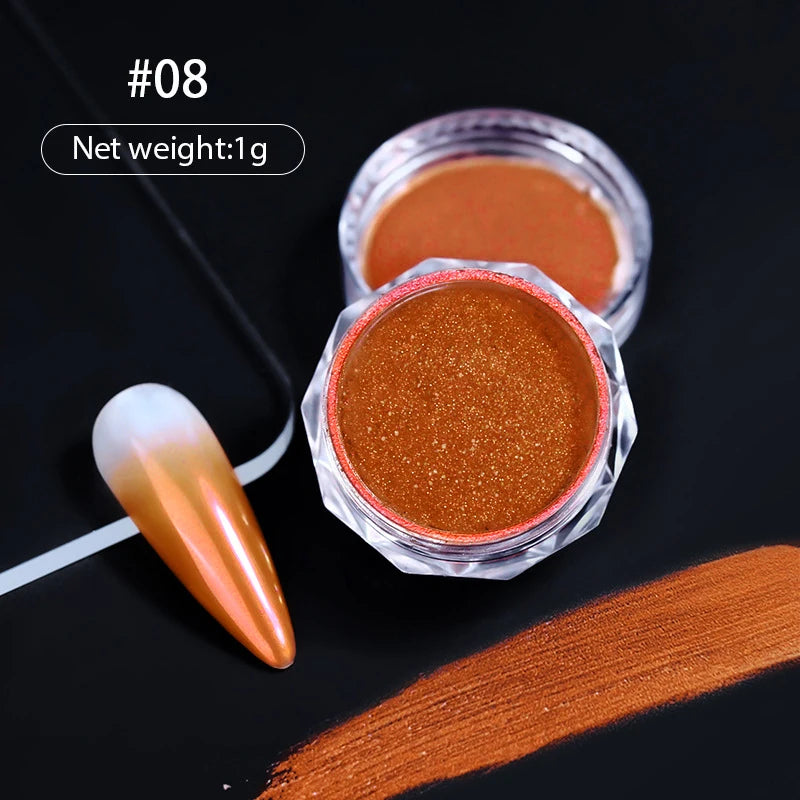 A small glass jar of orange-colored nail glitter powder next to a single orange chrome nail and a swatch of the same color.