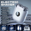A white electric shaver with a silver head and charging port is shown on a dark gray background.