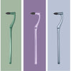A manual tooth stain remover tool with an interdental brush shown in three different shades of green and purple.