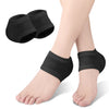 Black silicone heel protectors worn on a person's foot.