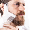 A man is using a clear plastic beard shaping tool on his face to style his beard.