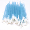 A bundle of clear blue crystal lip brushes with white tips and lash spoolies.