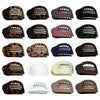 A collection of oval flat hair clips in various colors including black brown purple and white.