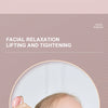 A woman receives facial massage using a pink resin roller tool on her face.