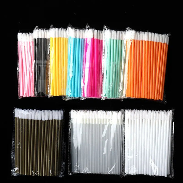 A collection of disposable lip brushes with nylon applicator wands in various colors, including pink, blue, green, and orange