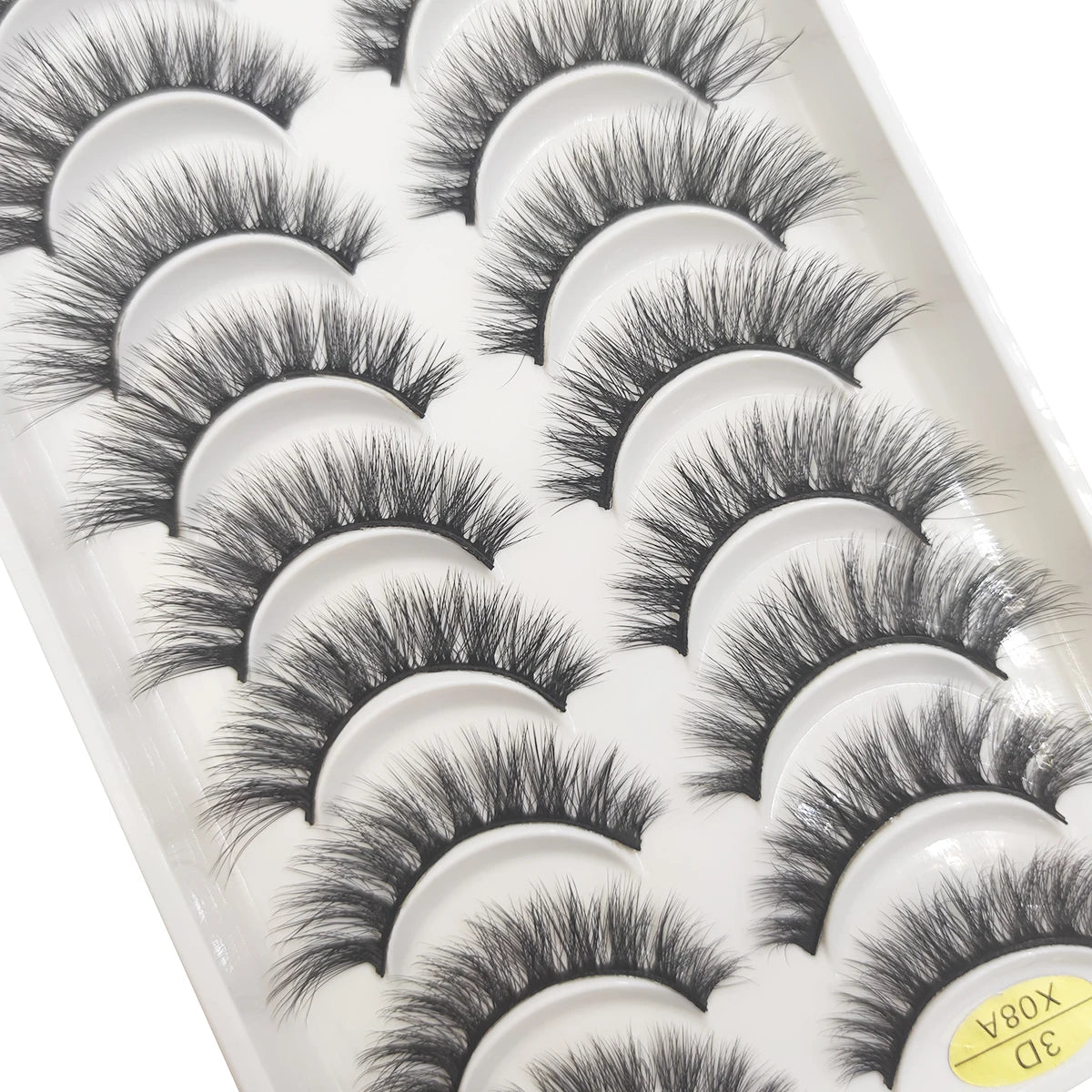 A tray of natural 3D mink false eyelashes displayed in individual cups.