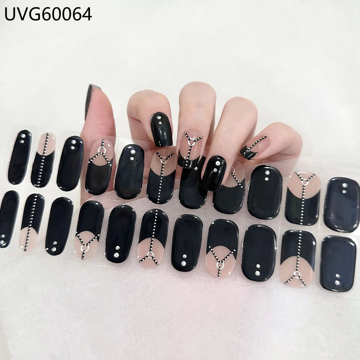 A display of Halloween UV gel nail stickers featuring black and white designs on various fingernails.
