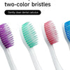 Un juego de dos cepillos de dientes de seda suave y afilada en varios tonos de morado, verde azulado y rosa.