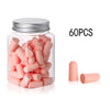 A glass jar filled with 60 pink memory foam earplugs and several loose earplugs.
