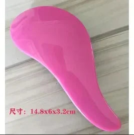 A bright pink classic detangling hair brush shown from the side.