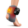 A person's ankle and foot is shown with a gray massager device applied to the skin.